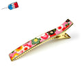 Grande pince cheveux crocodile avec décor fleurs de cerisier sur fond rose
