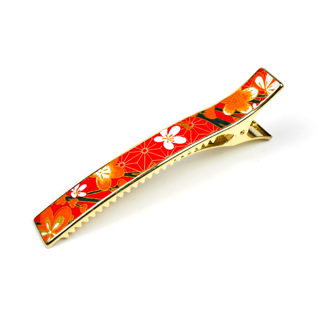 Grande pince cheveux crocodile avec décor fleurs de cerisier sur fond orangé