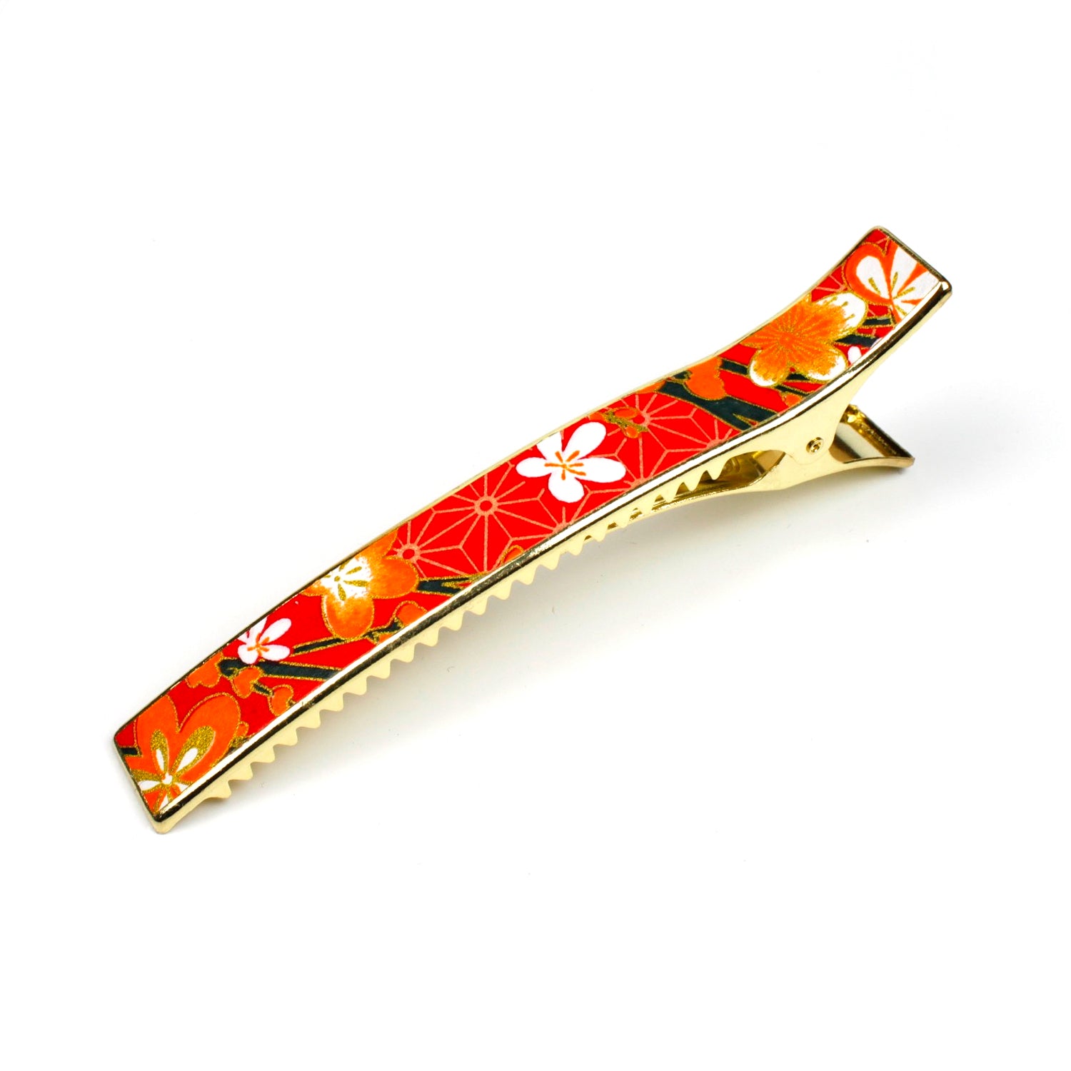 Grande pince cheveux crocodile avec décor fleurs de cerisier sur fond orangé